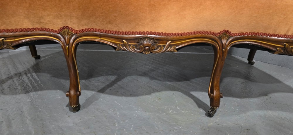 A French Louis XV style carved walnut settee with warm amber velvet upholstery, serpentine seat rail, and cabriole legs. View VI