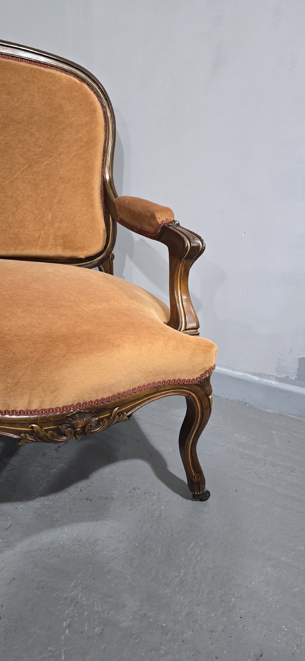A French Louis XV style carved walnut settee with warm amber velvet upholstery, serpentine seat rail, and cabriole legs. View VII