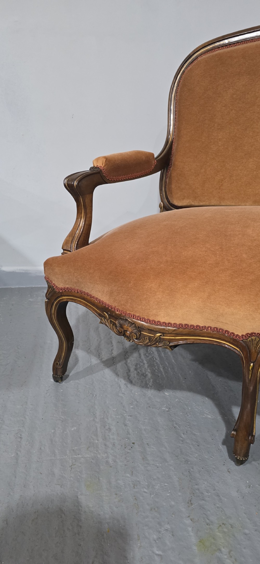 A French Louis XV style carved walnut settee with warm amber velvet upholstery, serpentine seat rail, and cabriole legs. View VIII