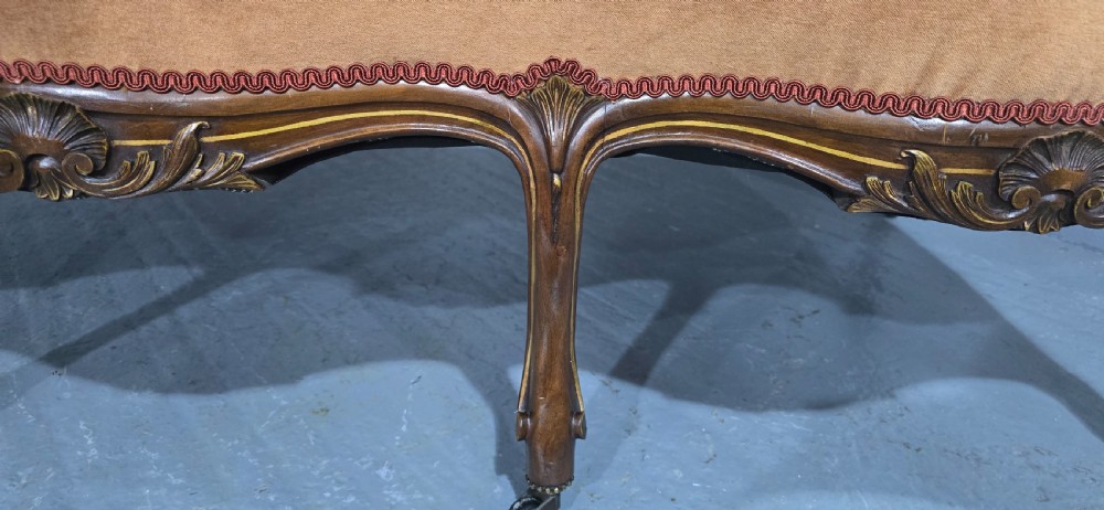 A French Louis XV style carved walnut settee with warm amber velvet upholstery, serpentine seat rail, and cabriole legs. View XI