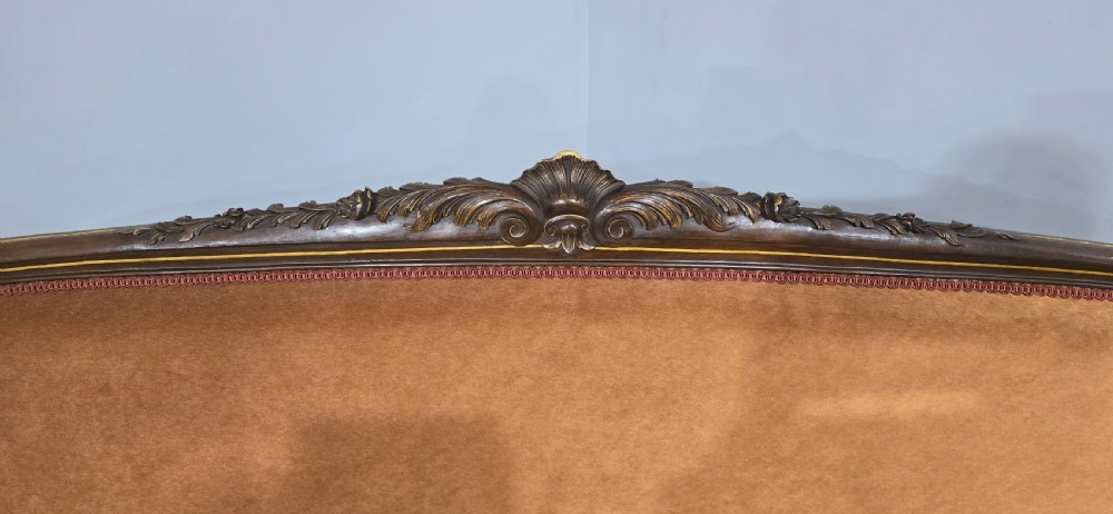 A French Louis XV style carved walnut settee with warm amber velvet upholstery, serpentine seat rail, and cabriole legs. View XIV