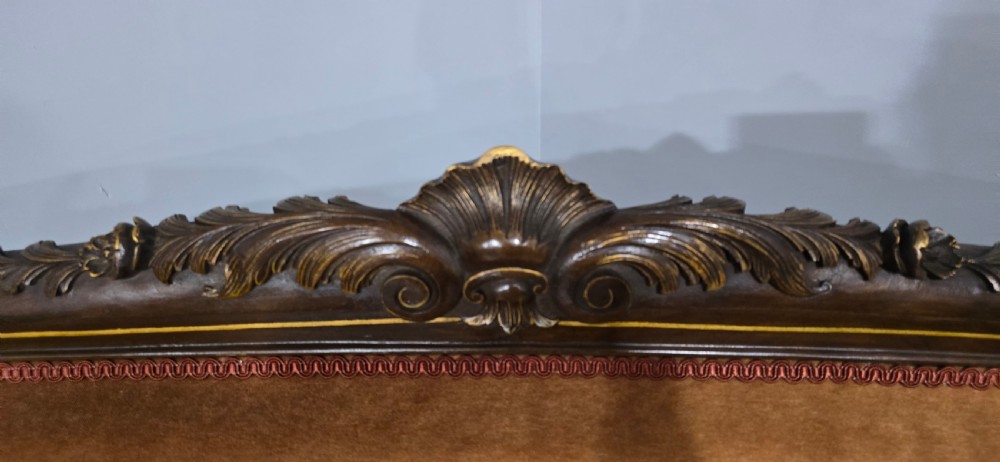 A French Louis XV style carved walnut settee with warm amber velvet upholstery, serpentine seat rail, and cabriole legs. View XV