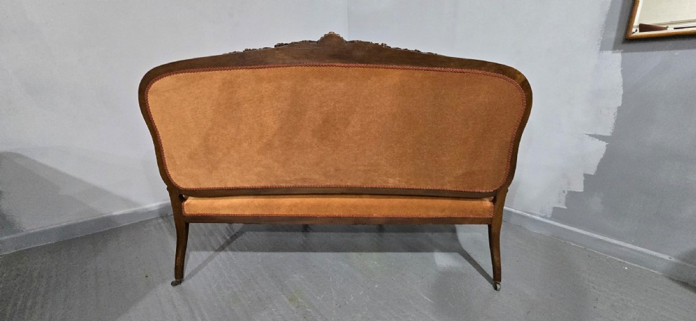 A French Louis XV style carved walnut settee with warm amber velvet upholstery, serpentine seat rail, and cabriole legs. View XVII