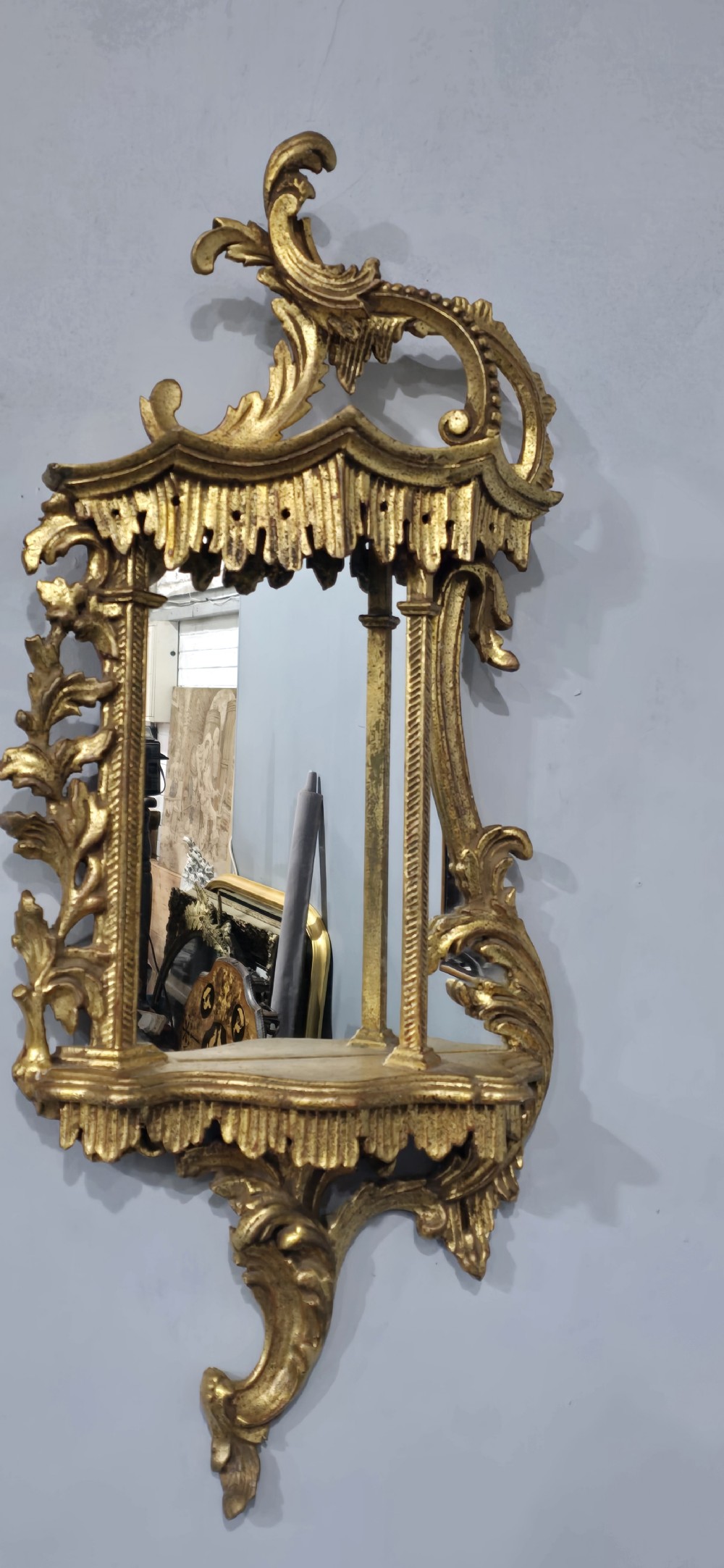 A pair of carved giltwood wall mirrors featuring Chinese Chippendale pagoda crestings and Rococo C-scroll motifs. View IX