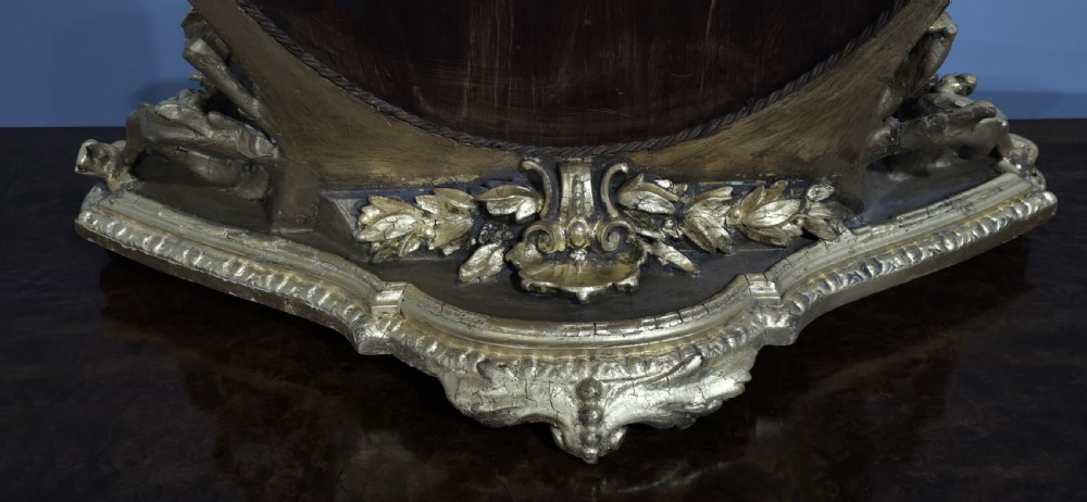An oval gilt metal dressing table mirror with a top floral wreath cresting and an acanthus leaf scroll base. View XIII