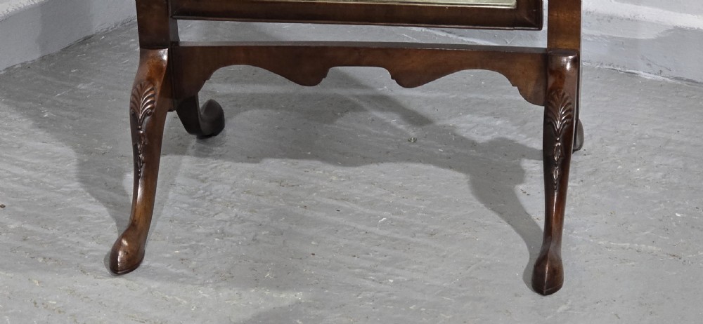 A full-length antique walnut cheval mirror featuring an arched top frame, turned vertical supports with finials, and carved cabriole legs. View III