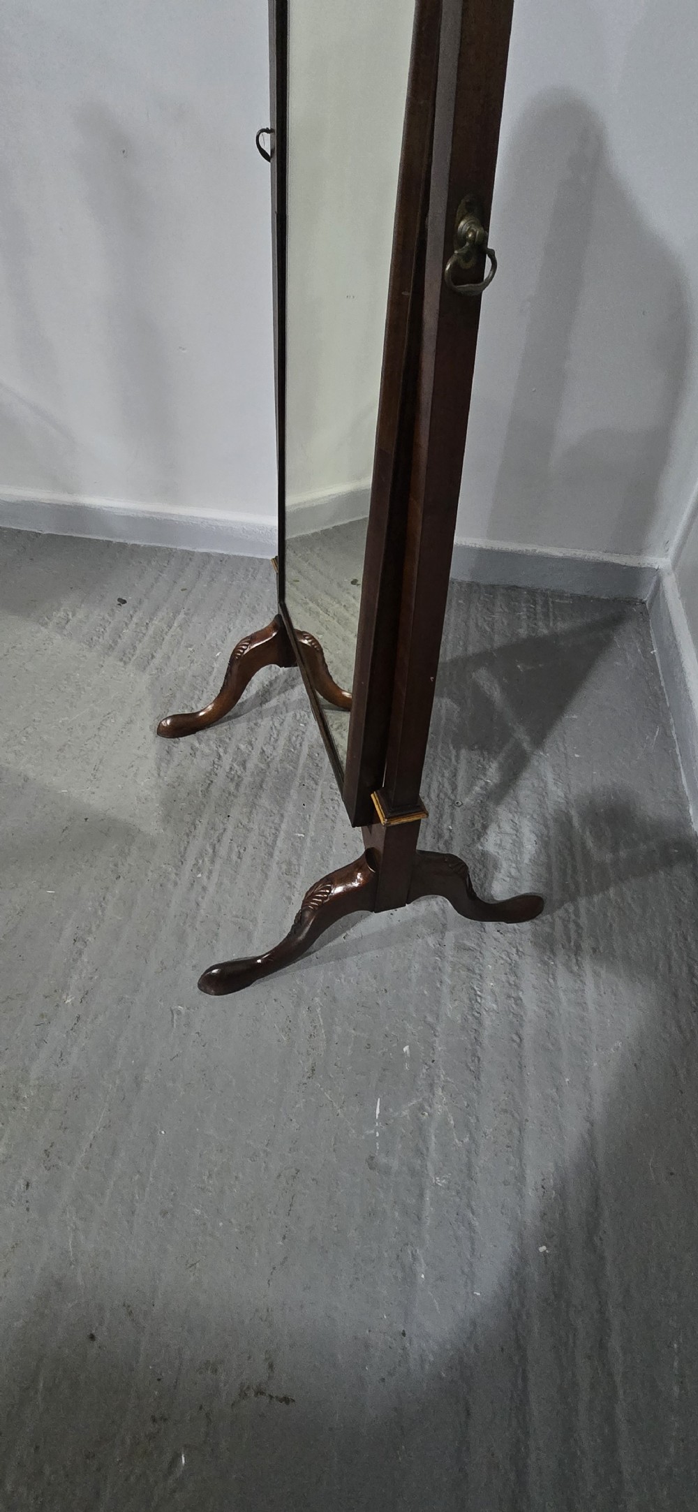 A full-length antique walnut cheval mirror featuring an arched top frame, turned vertical supports with finials, and carved cabriole legs. View IX