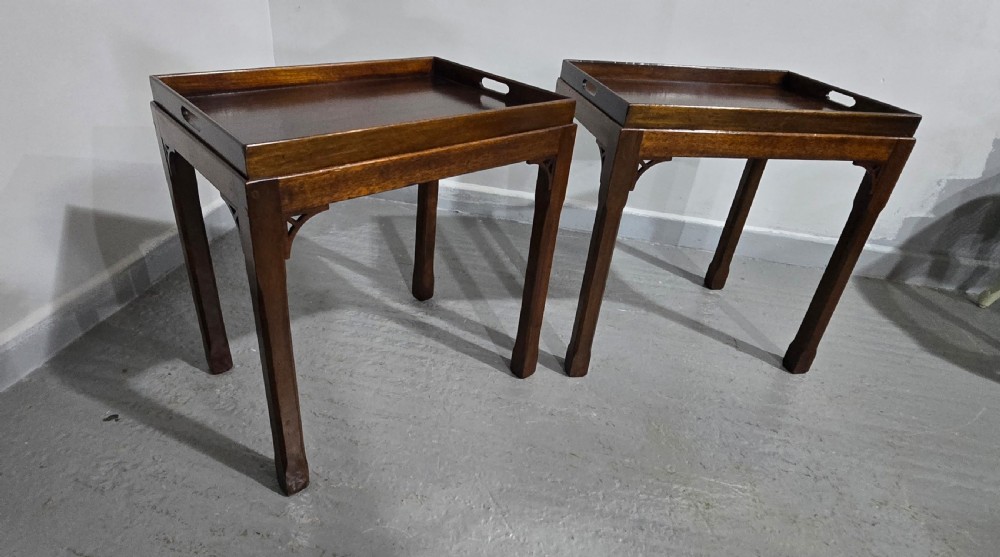 A pair of dark mahogany rectangular lamp tables featuring tray tops with cut-out handles and decorative fretwork corner brackets on straight legs. View IX