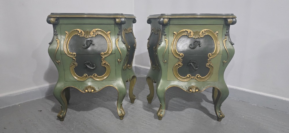 A pair of sage green and gold painted French Louis XV style bedside chests featuring bombee sides, cabriole legs, and ornate scroll moulding. View III