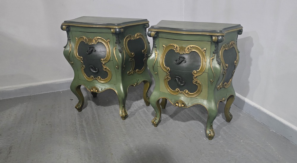 A pair of sage green and gold painted French Louis XV style bedside chests featuring bombee sides, cabriole legs, and ornate scroll moulding. View VIII