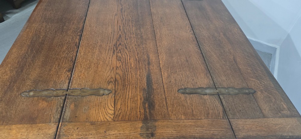 A long rectangular dark oak refectory dining table featuring turned wooden legs, a central stretcher, and a plank top. View VII