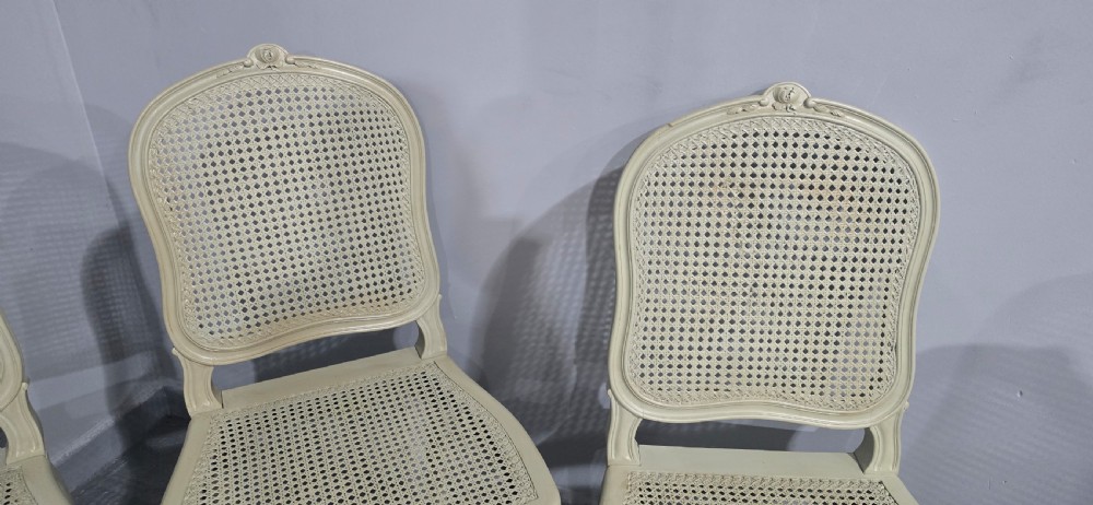 A set of six French-style dining chairs painted in pale grey with woven cane backrests, cane seats, and carved cabriole legs. View VIII