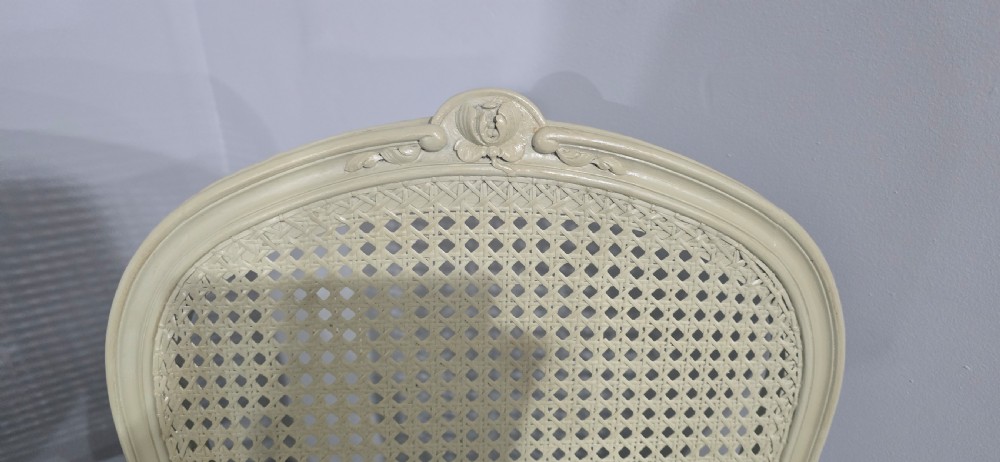 A set of six French-style dining chairs painted in pale grey with woven cane backrests, cane seats, and carved cabriole legs. View IX