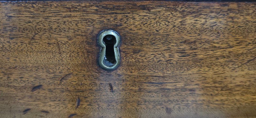 A Georgian mahogany kneehole desk featuring a long top drawer, six side drawers, a central recessed cupboard, brass swan-neck handles, and bracket feet. View XII