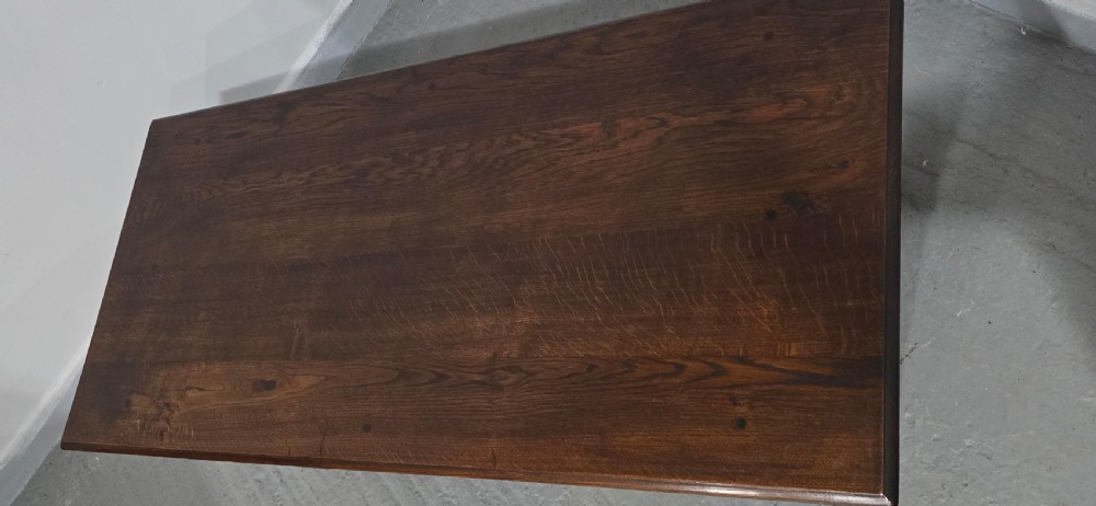 A rectangular dark oak coffee table featuring a plank top, turned legs, and a lower slatted shelf. View X
