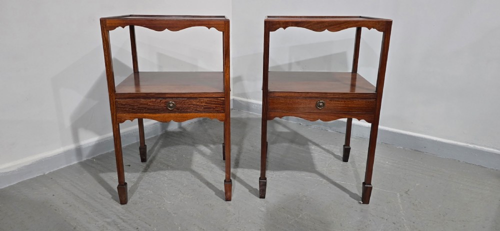A pair of Georgian mahogany bedside tables featuring square tray tops, open upper shelves, single drawers with brass ring handles, and square tapered legs. View III