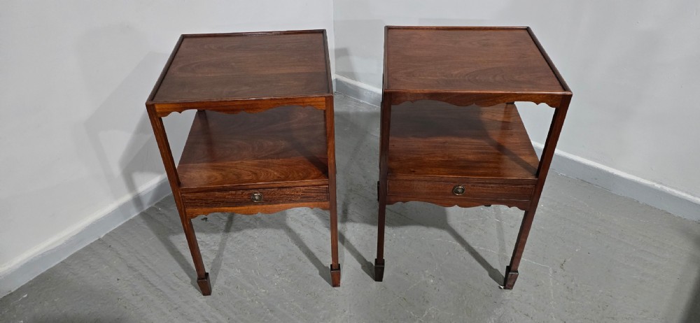 A pair of Georgian mahogany bedside tables featuring square tray tops, open upper shelves, single drawers with brass ring handles, and square tapered legs. View VII