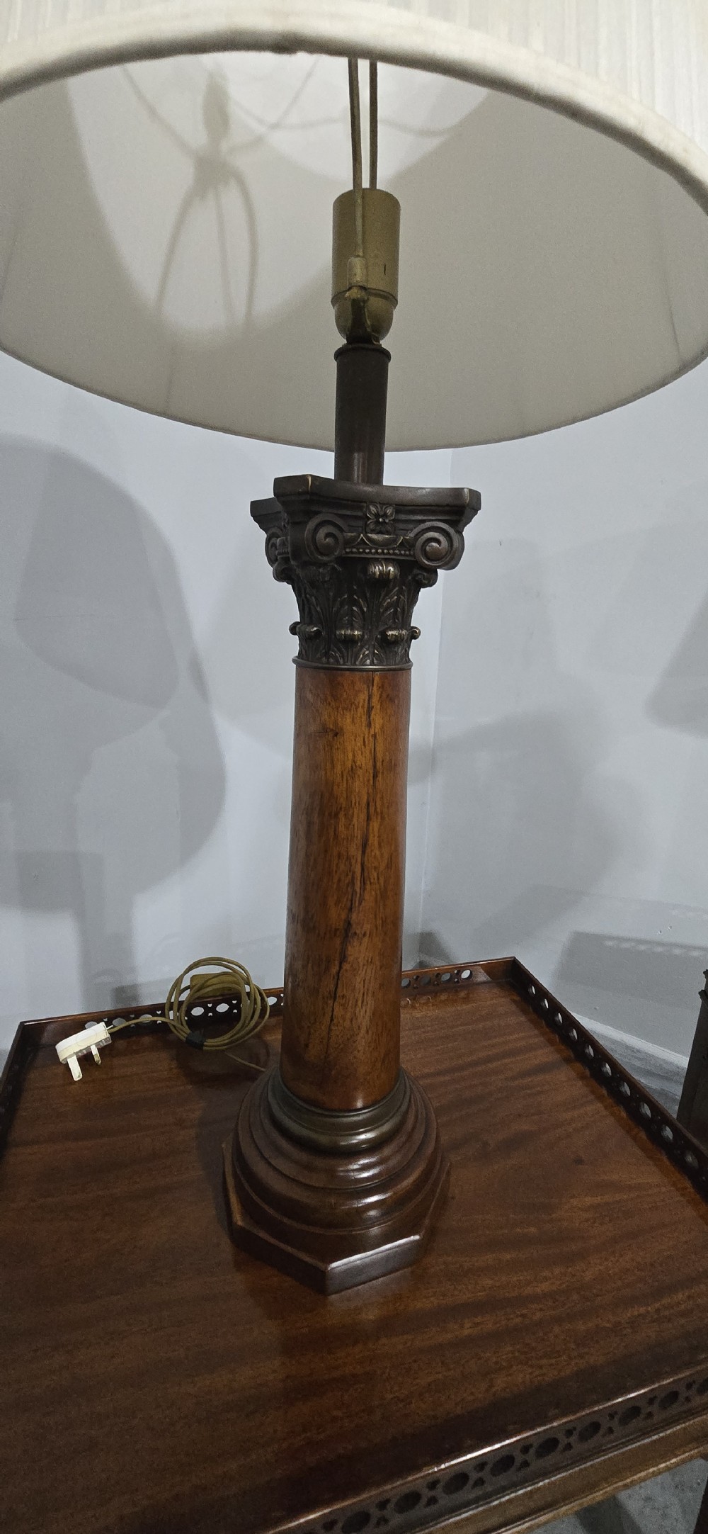 A pair of dark oak table lamps crafted in the form of Corinthian columns, topped with pleated white shades. View II
