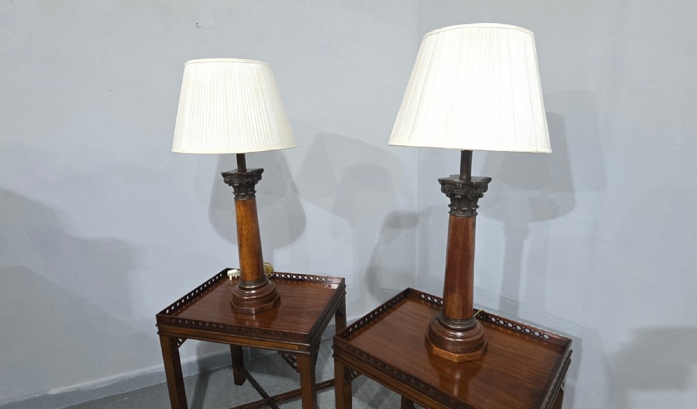 A pair of dark oak table lamps crafted in the form of Corinthian columns, topped with pleated white shades. View VII