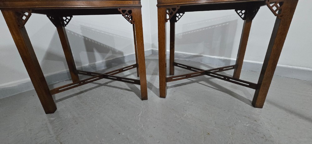 A matching pair of dark mahogany Chippendale-style lamp tables featuring pierced fretwork galleries, corner brackets, and X-frame stretchers. View III