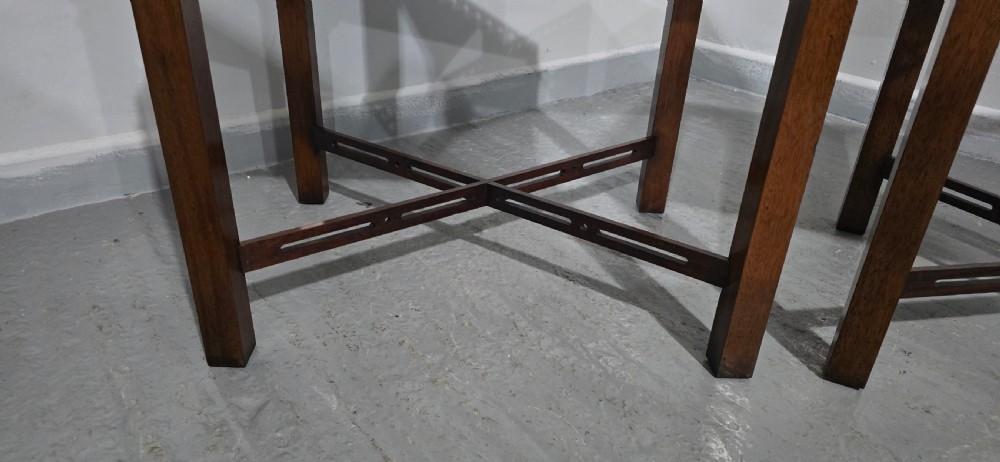 A matching pair of dark mahogany Chippendale-style lamp tables featuring pierced fretwork galleries, corner brackets, and X-frame stretchers. View VI