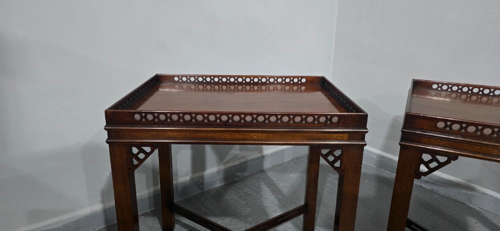 A matching pair of dark mahogany Chippendale-style lamp tables featuring pierced fretwork galleries, corner brackets, and X-frame stretchers. View VII