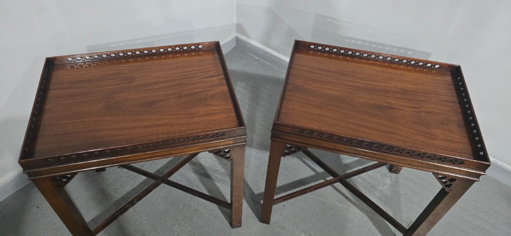 A matching pair of dark mahogany Chippendale-style lamp tables featuring pierced fretwork galleries, corner brackets, and X-frame stretchers. View VIII