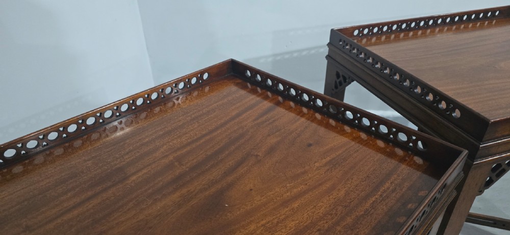 A matching pair of dark mahogany Chippendale-style lamp tables featuring pierced fretwork galleries, corner brackets, and X-frame stretchers. View IX