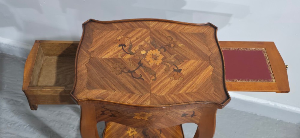 A pair of slender warm brown French marquetry tables featuring floral inlays, cabriole legs, lower shelves, and extended side drawers. View V