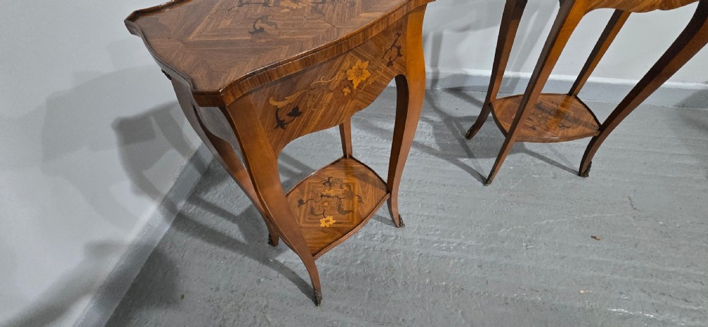 A pair of slender warm brown French marquetry tables featuring floral inlays, cabriole legs, lower shelves, and extended side drawers. View VIII
