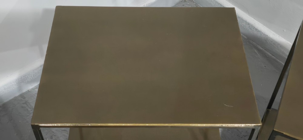 A pair of rectangular dark bronzed metal lamp tables featuring slender square legs and an integrated lower tier shelf. View III
