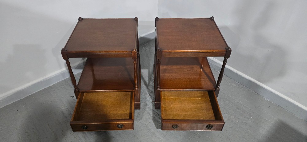 A pair of dark mahogany two-tier lamp tables with turned corner supports and single base drawers featuring brass ring handles. View V