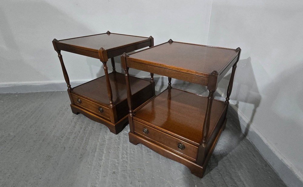 A pair of dark mahogany two-tier lamp tables with turned corner supports and single base drawers featuring brass ring handles. View VI