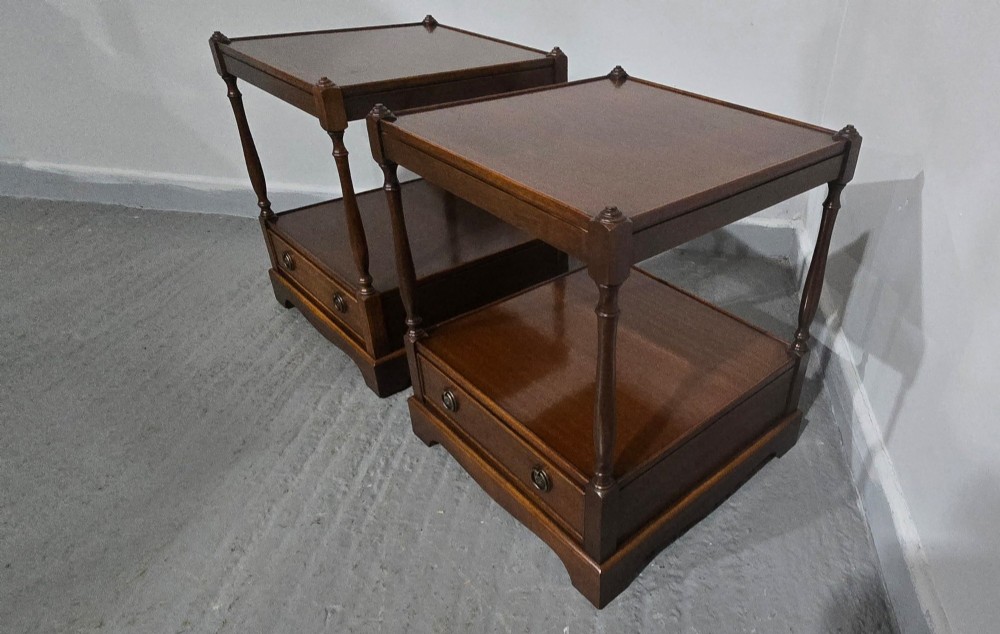 A pair of dark mahogany two-tier lamp tables with turned corner supports and single base drawers featuring brass ring handles. View VII