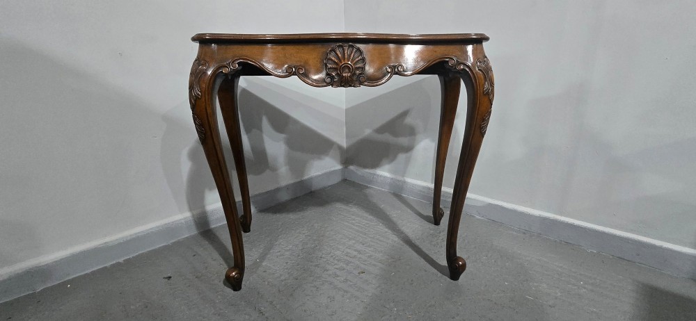 A dark mahogany console table featuring a shaped serpentine top, a central shell carving on the apron, and four cabriole legs. View III