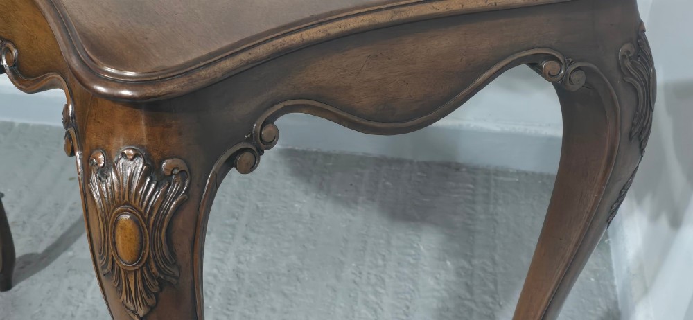 A dark mahogany console table featuring a shaped serpentine top, a central shell carving on the apron, and four cabriole legs. View VIII