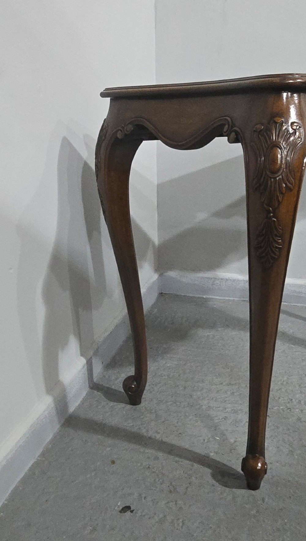 A dark mahogany console table featuring a shaped serpentine top, a central shell carving on the apron, and four cabriole legs. View XIV