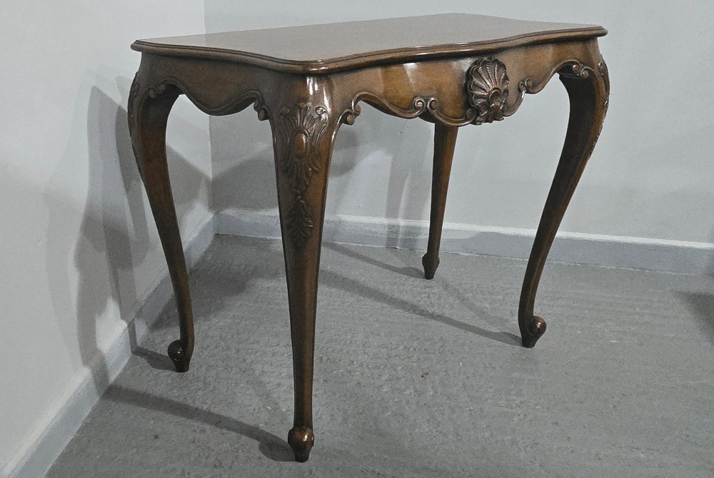 A dark mahogany console table featuring a shaped serpentine top, a central shell carving on the apron, and four cabriole legs. View XV