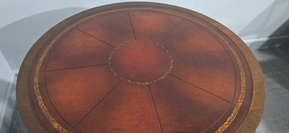 A circular mahogany occasional centre table with a segmented veneered top, brass lion mask handle, and curved reeded legs. View XIII