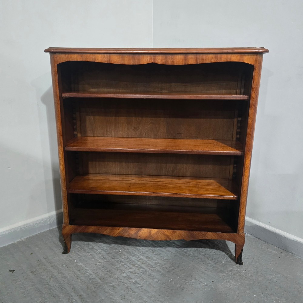 An open-fronted French walnut bookcase featuring adjustable internal shelves, a shaped apron, and short cabriole legs. View II