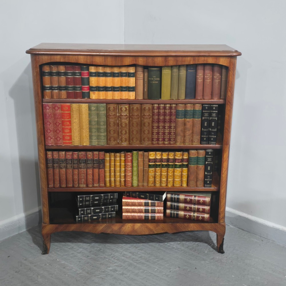 An open-fronted French walnut bookcase featuring adjustable internal shelves, a shaped apron, and short cabriole legs. View IV