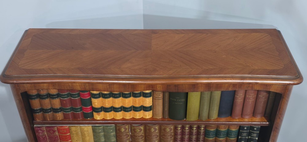 An open-fronted French walnut bookcase featuring adjustable internal shelves, a shaped apron, and short cabriole legs. View VII