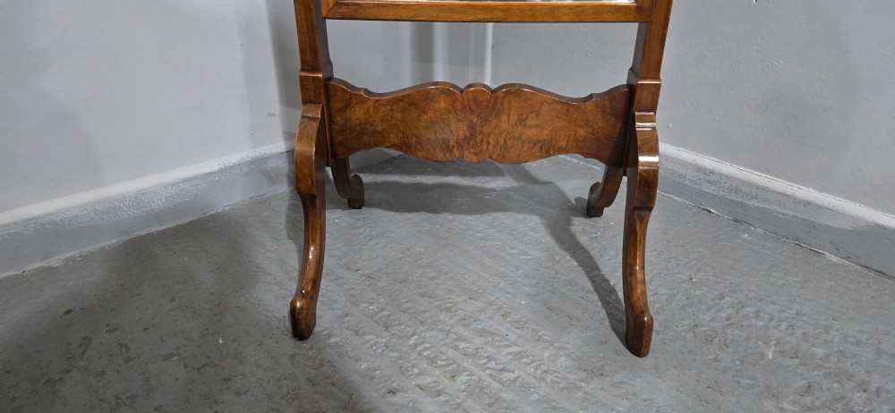 A standing Queen Anne style burr walnut cheval mirror featuring a shaped crest, tilting glass plate, finial-topped uprights, and cabriole legs. View III