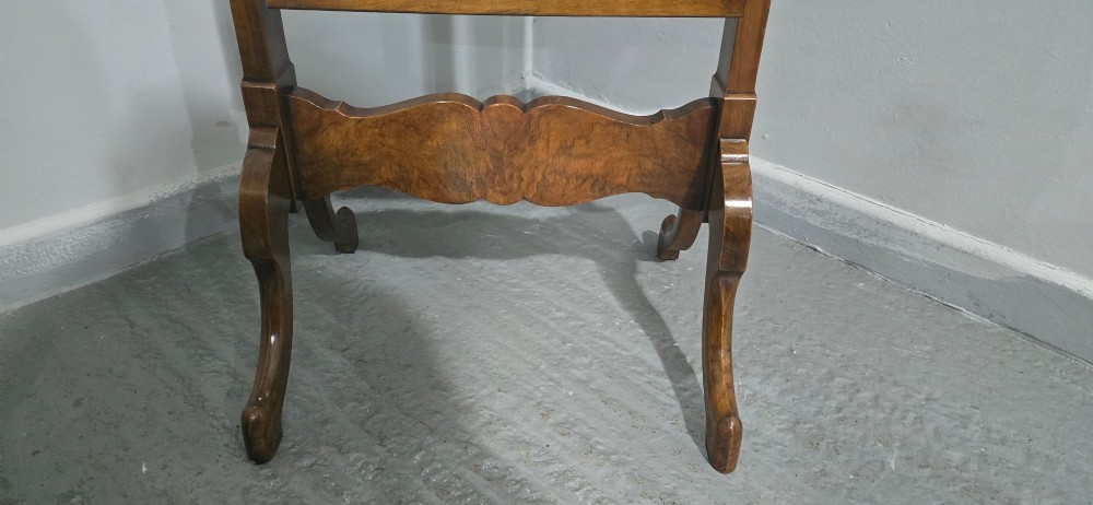 A standing Queen Anne style burr walnut cheval mirror featuring a shaped crest, tilting glass plate, finial-topped uprights, and cabriole legs. View IX