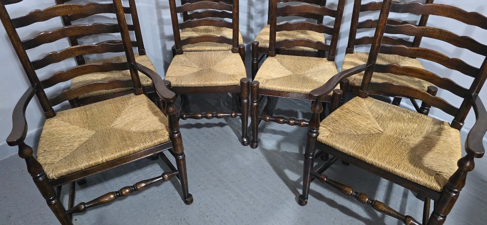 A set of eight dark oak ladder back dining chairs featuring woven rush seats, curved back rungs, and turned front legs with stretchers. View VI