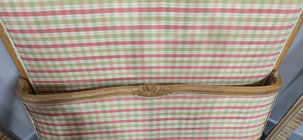 A French double bed frame with a limed wood structure, featuring floral crest carvings, fluted details, and check pattern upholstery. View VIII