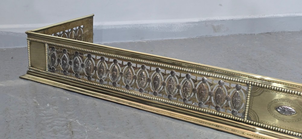 A wide Georgian brass and pierced cut steel fireplace fender with decorative geometric patterns and beaded borders. View VI