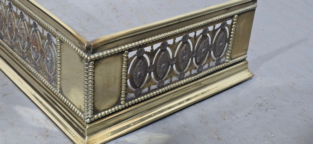A wide Georgian brass and pierced cut steel fireplace fender with decorative geometric patterns and beaded borders. View VII