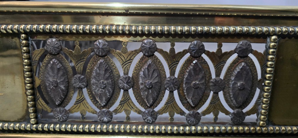 A wide Georgian brass and pierced cut steel fireplace fender with decorative geometric patterns and beaded borders. View IX