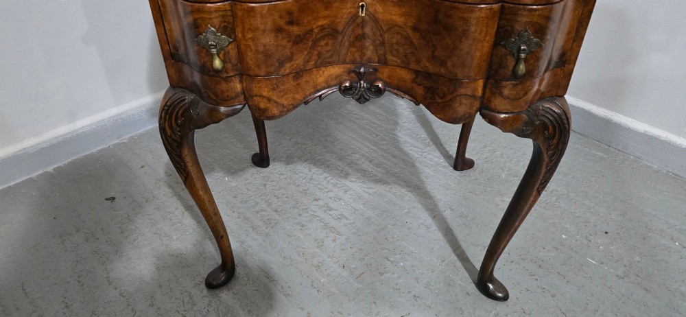 A Queen Anne style burr walnut writing bureau featuring a sloped front lid, shaped drawers with brass drop handles, and tall cabriole legs. View III